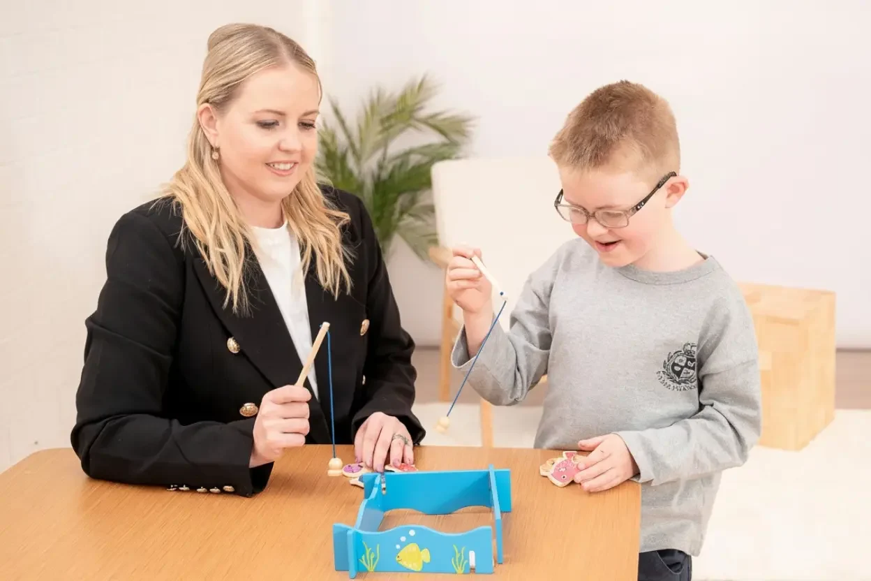 Image of a female adult playing a fishing game with a child for Contact the Child Centred Learning Tree page cchild development consultation