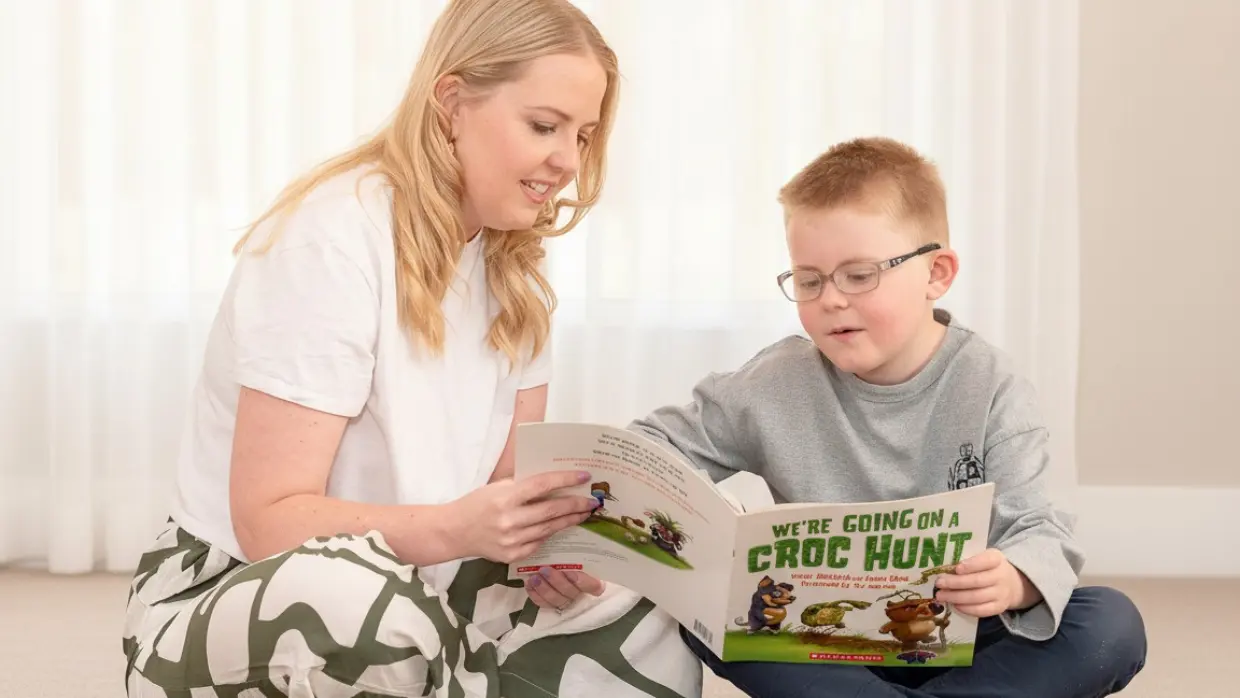 Adult and child reading together, symbolising family learning support and child development guidance.